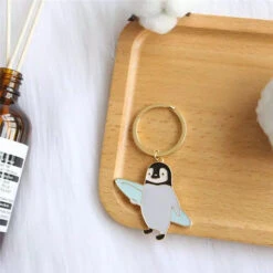 Porte Clés Pingouin Surfeur -Animalière Décoration Magasin file 2219